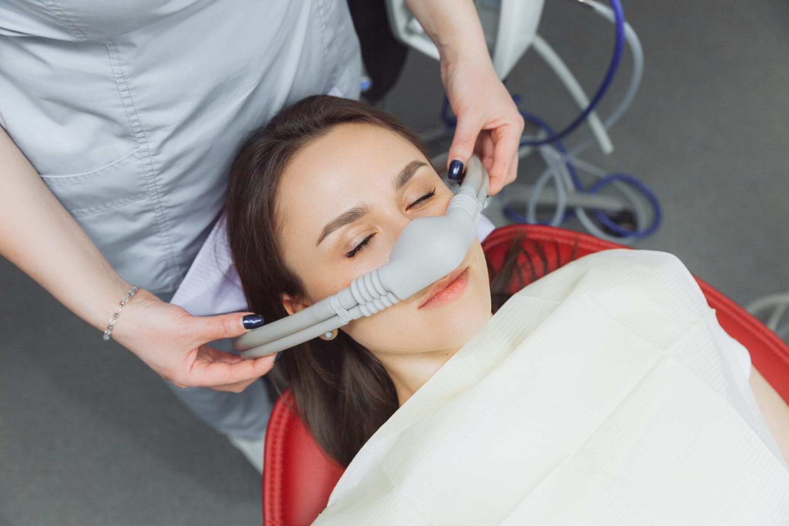 A female patient wearing a nitrous oxide mask for sedation